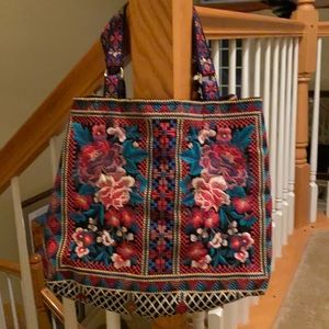 Very colorfu embroidered expandable tote bag.